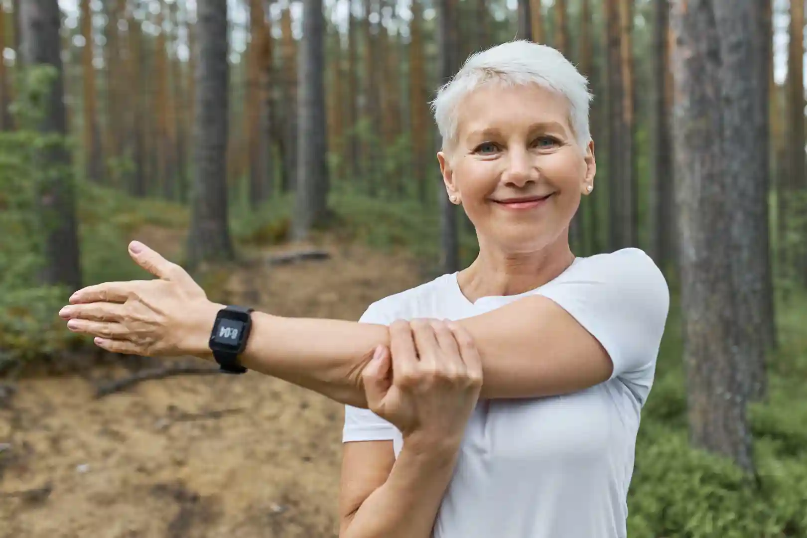 portrait-short-haired-retired-female-wearing-whit-t-shirt-smart-watch-her-wrist-track-progress-running tennis elbow brace